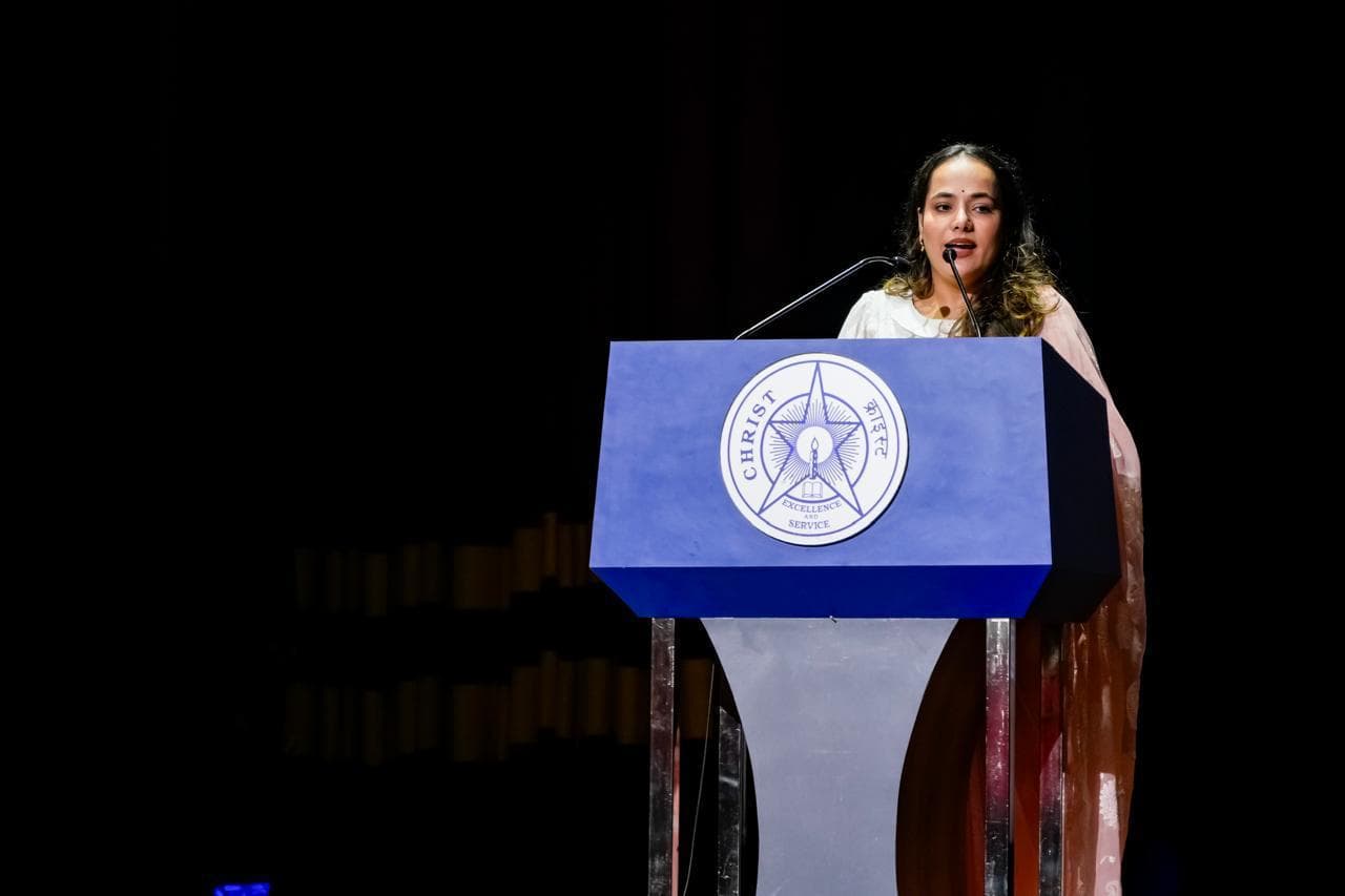 Gunjan Singh speaking at the podium, Prayaan '25 inaugural ceremony